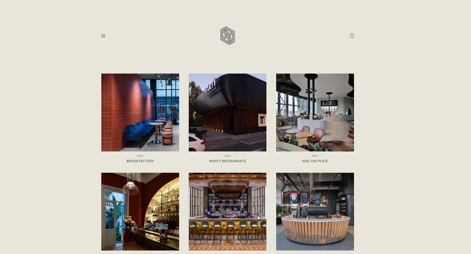 Storefront home page of the Folio preset in a centered fixed width layout, with wide beige body background margins around a centered header and a three-column grid of project images titled Brush Factory, Marty Restaurants and Hug the Plate.